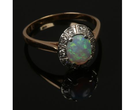 An 18ct gold opal and diamond ring, size P. (Approx Width 6mm, Length 8mm, Depth 3mm) (Gross Weight 3.3g).Condition report in