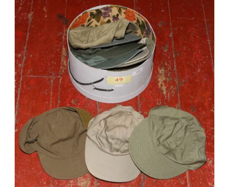 Eleven military issue and reproduction caps including a genuine World War II summer type B-1 flying cap, a genuine US Army A-