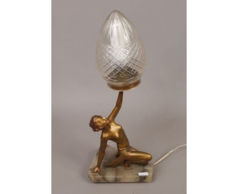 An Art Deco gilt Spelter figural table lamp formed as a kneeling semi clad maiden with associated pear formed cut glass shade