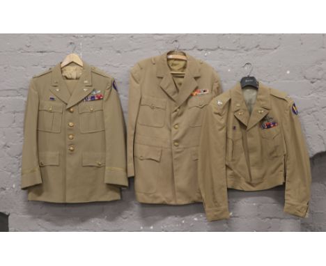 A post war genuine US Navy light tan jacket with insignia, along with a similar World War II pattern labelled US regulation A