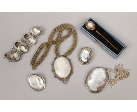 A collection of jewellery; shell cameo pendents, continental silver bracelet and similar yellow metal stick pin.