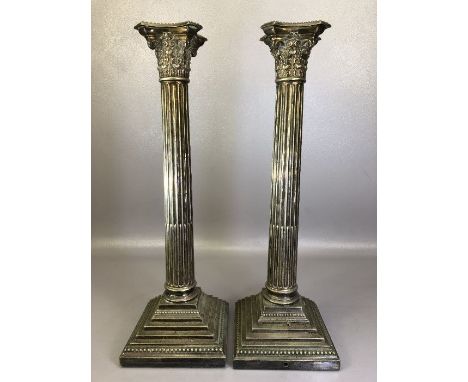 PAIR OF SILVER COLOURED LARGE CORINTHIAN COLUMN lamp bases, maker Walker &amp; Hall, on weighted, stepped and beaded square s