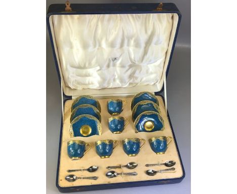 Cased Royal Worcester set of six coffee cans and saucers, decorated with teal ground and a band of gilt scrolling foliage, wi