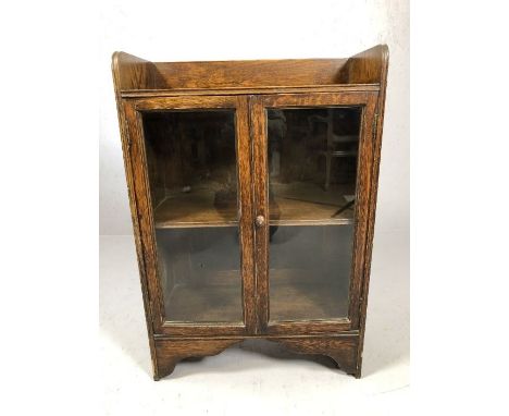 Two door glazed wooden book shelf, approx 60cm x 30cm x 88cm tall