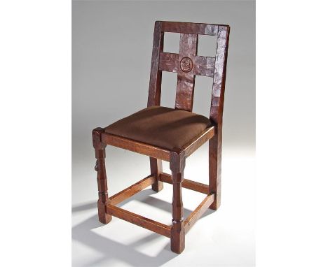 1930's Robert ``Mouseman`` Thompson oak chair, the cross splat back with a carved knights head recessed motif, drop in seat a