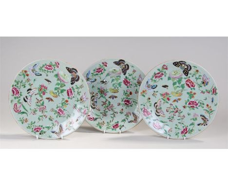 Set of three 19th Century Canton enamel plates, decorated with insects and flowers with celadon green ground, 26cm diameter (
