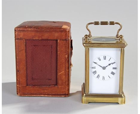 Early 20th Century gilt brass carriage clock, with a corniche case, oval bevel glass to the top, four glass section to the ba