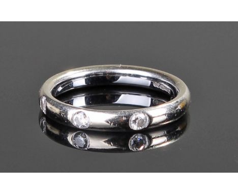 18 carat white gold and diamond set wedding band, set with three diamonds, ring size K 1/2