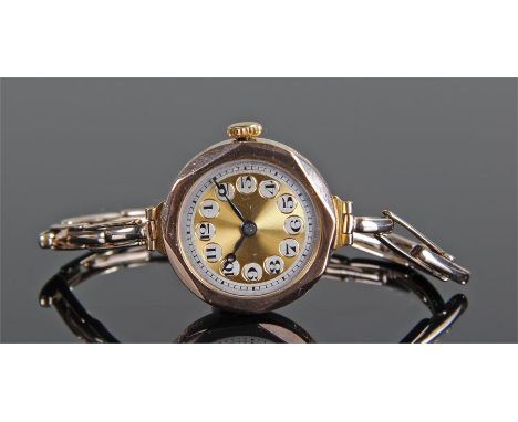 9 carat gold ladies wristwatch, the 9 carat gold case with a silvered and gilt dial, black Arabic hours, 9 carat gold elastic