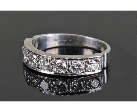 18 carat white gold diamond set ring, with seven diamonds in a row, each approximately 0.11 carats in size, ring size P