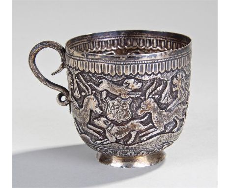 19th Century Indian white metal cup, decorated in high relief with various animals hunting, snake loop handle, 7cm high 