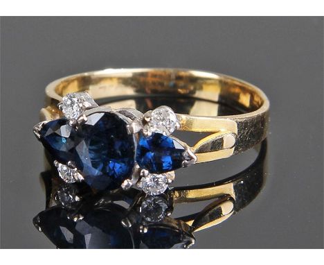 18 Carat gold sapphire and diamond ring, with three sapphires set above four diamonds, ring size T