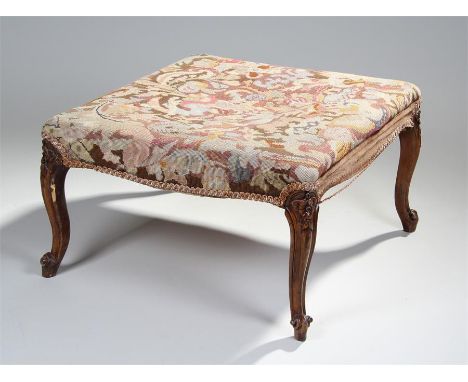 19th Century walnut stool, the square seat with stuff over tapestry, raised on flower carved cabriole legs, 64cm wide, 37cm h