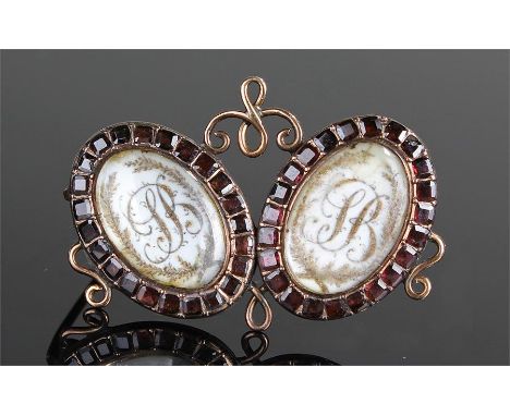 19th Century gold and garnet set brooch, the two oval garnet set panels with enamel B plaques, 3.7cm wide