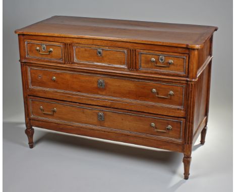 Early 19th Century French walnut commode, the rectangular top with rounded corners above three short and two long drawers, st