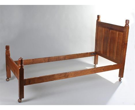 1930's Robert ``Mouseman`` Thompson oak single bed, the thumb moulded top rail held by block carved supports, carved mouse si