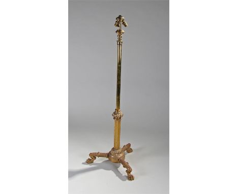 Edwardian electric brass standard lamp, the three light fitted telescopic column with three cast paw feet, 128cm when lowered