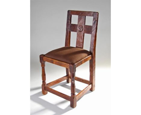 1930's Robert ``Mouseman`` Thompson oak chair, the cross splat back with a carved squirrel recessed motif, drop in seat above