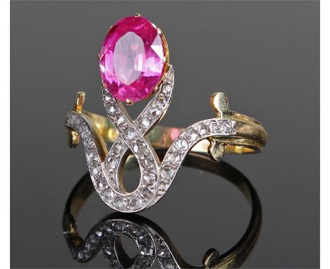 Yellow metal ruby and diamond ring, the oval approximately 1.8 carat ruby above a cross ribbon design diamond set design, rin