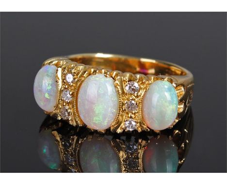 18 carat gold opal and diamond ring, with three opals and six diamonds, wide leaf engraved shank, ring size M