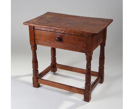 1930's Robert ``Mouseman`` Thompson oak side table, the overhanging top with tail carved corners, above a single frieze drawe