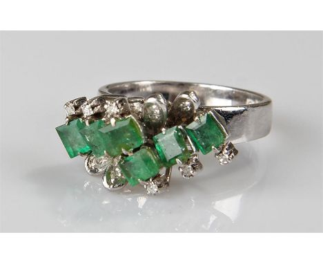 18 carat white gold emerald and diamond ring, the six princess cut emeralds to the centre with fourteen diamonds to the edge,