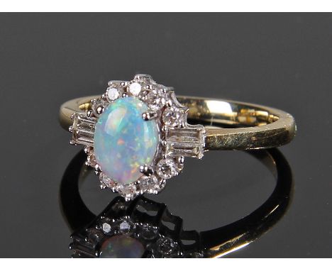 18 carat gold diamond and opal ring, with a central oval opal flanked with baguette and round cut diamonds, ring size N 1/2