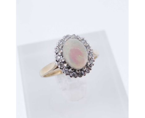 9CT GOLD OPAL & DIAMOND OVAL CLUSTER RING, the cabochon opal surrounded by a row of tiny diamonds, Birmingham 1987, ring size