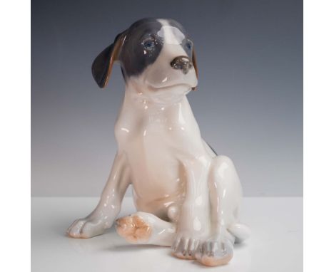 Charming Royal Copenhagen porcelain figurine depicting a young pointer puppy seated with a relaxed yet curious expression. Th
