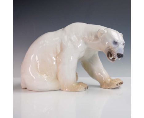 This finely sculpted porcelain figurine by Danish maker Bing &amp; Grondahl features a powerful polar bear in a tense, crouch