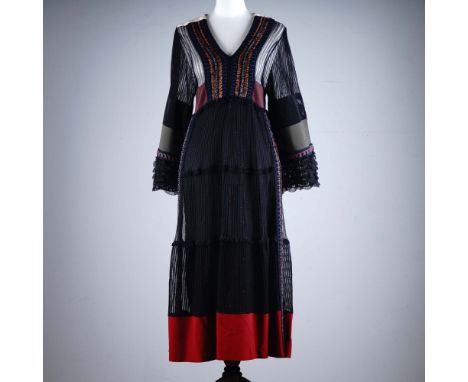 Striking Valentino party dress featuring richly textured fabrics and embroidered ribbon detailing, combining sheer black stri