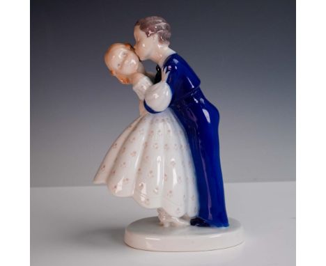 A charming porcelain figurine titled Youthful Boldness by Bing &amp; Grondahl, depicting a young boy stealing a kiss from a g