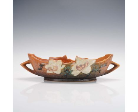 From Roseville's 1943 Magnolia line, this console bowl is adorned with creamy white magnolia blossoms blooming from textured 