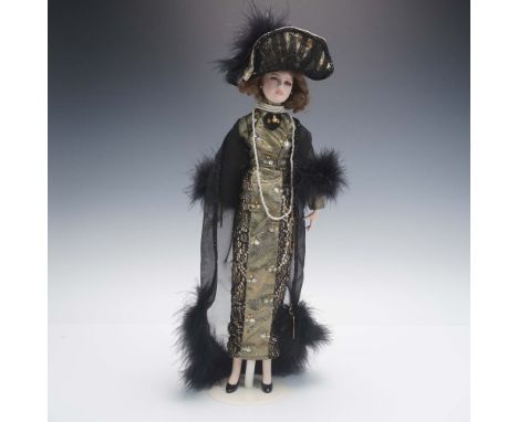 This Seymour Mann porcelain doll from the Signature Series Connoisseur Collection features a hand painted face with glass-lik