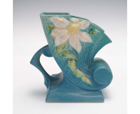This is a vintage Roseville Pottery vase from the Clematis collection, featuring the classic cornucopia form. Crafted in the 