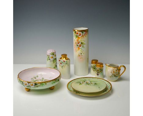 This vibrant 9-piece collection features hand painted floral motifs on fine porcelain from Bavaria and Limoges, France. Inclu