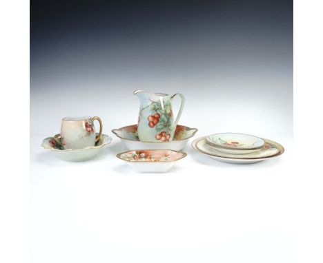 Collection of nine hand painted porcelain pieces featuring vibrant red cherry motifs and delicate gilded rims. Includes a tal