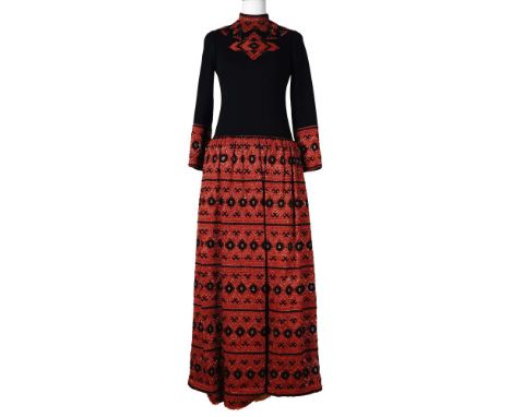 Striking vintage full-length evening sweater dress in a dramatic black and red palette, featuring an ornate folk-inspired geo