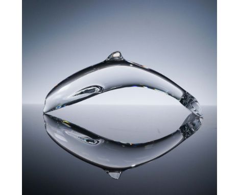 This Baccarat crystal dolphin figurine gracefully captures the fluid motion of a dolphin mid-leap, rendered in brilliant clea