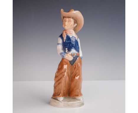 This 1988 porcelain figurine by Bing &amp; Grondahl, titled Billy, features a young boy dressed as a cowboy with wide-legged 