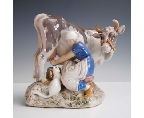 This Bing &amp; Grondahl porcelain figurine, designed by A. Vilhelm Locher, depicts a serene rural scene of a milk maid seate