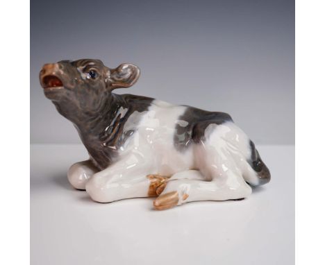 This endearing porcelain figurine by Royal Copenhagen depicts a calf lying down, head lifted as it moos longingly for its mot