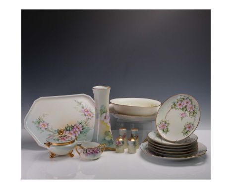 Collection of seventeen hand painted Limoges pieces featuring a cohesive floral motif in pink and green, each trimmed in gold