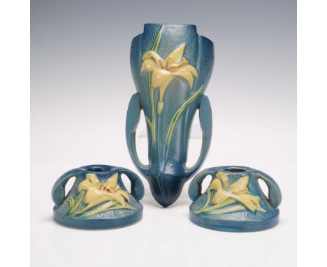 This 3-piece Roseville pottery set features the Zephyr Lily pattern in a rich blue glaze with embossed yellow lilies and gree