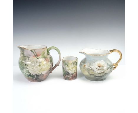Elegant 3-piece grouping of hand-painted Jean Pouyat Limoges porcelain, featuring two water pitchers and a matching tumbler, 