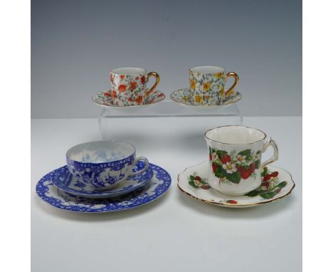 A delightful 9-piece collection of porcelain cups and saucers showcasing a mix of international makers and floral designs. Th
