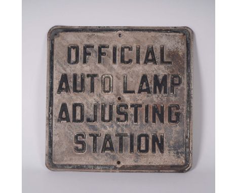 Authentic vintage cast iron sign reading Official Auto Lamp Adjusting Station, likely from a mid-century automotive service s