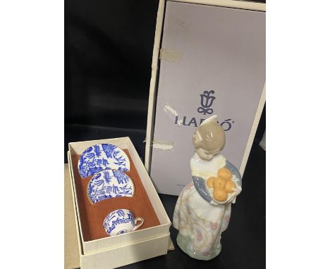 A boxed Lladro figurine with a boxed Coalport miniature china tea service