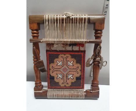An example of a Bedioun carpet loom in a wooden frame with associated tools. Size 40cm x 33cm