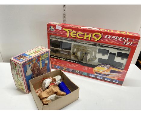 A boxed Tech 9 express train set with a boxed vintage battery operated basset hound (untested)